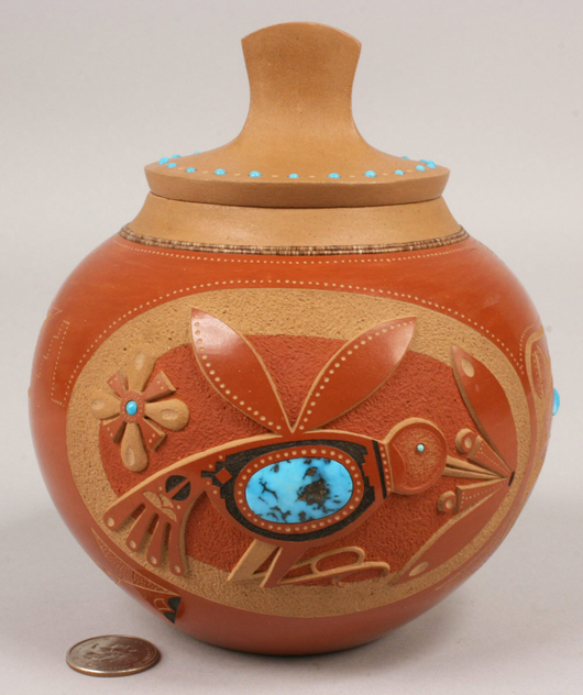 A red-glazed jar by San Ildefonso Pueblo potter Anthony Edward Tony Da (1940-2008) is decorated with hummingbirds and inset with turquoise stones. Measuring just 6 1/2 inches tall, it hit $35,650 (est. $4,000-6,000). Image courtesy of Case Antiques Inc.
